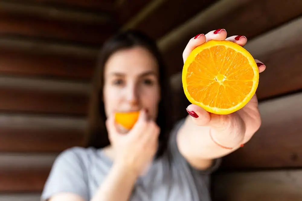 Girl eating an orange