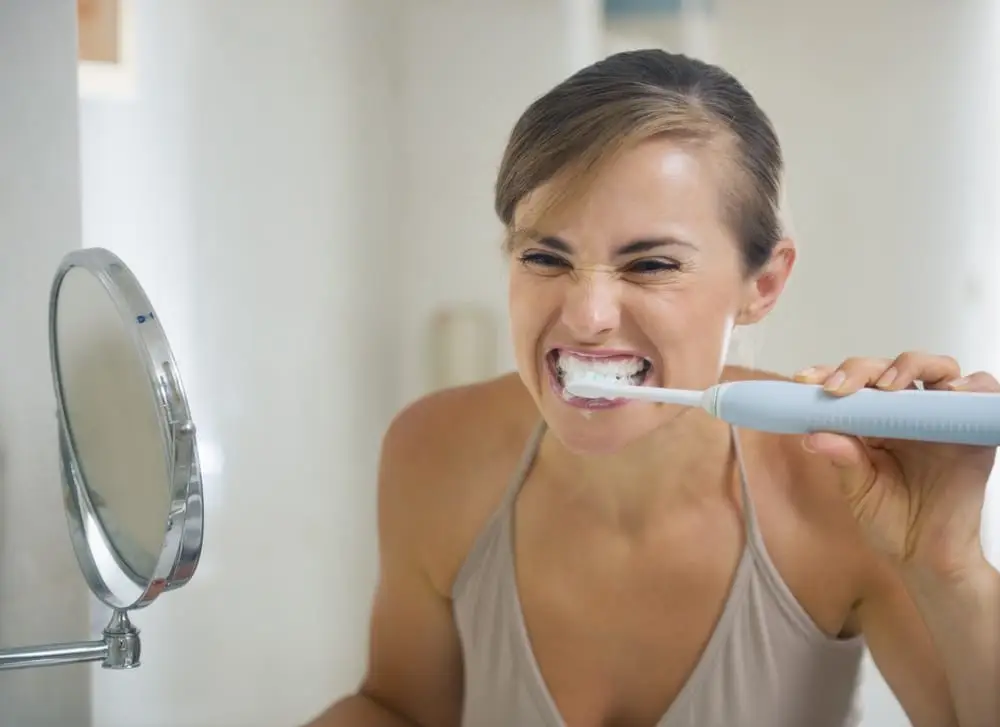 Young Woman Brushing Teeth